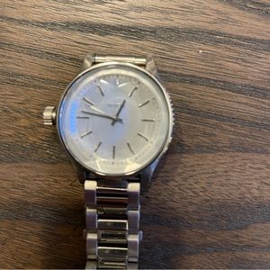 Nixon silver bezeled face woman’s watch